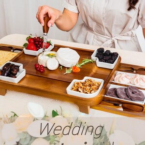a woman in a white shirt is cutting a berry