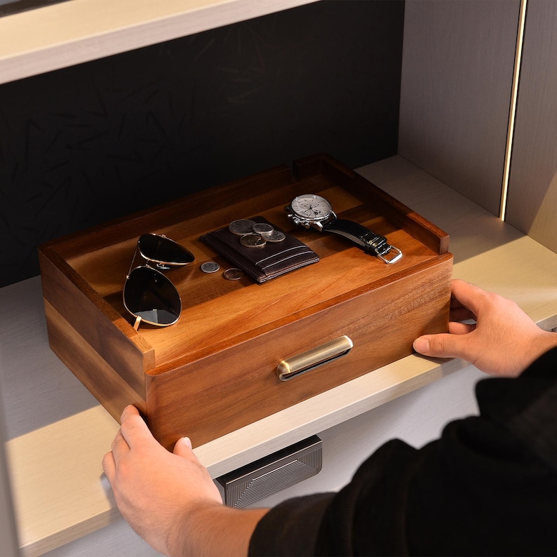 a person holding a wooden box with sunglasses on it