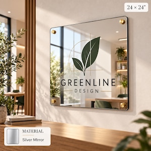 a large mirror with the text "GREENLINE DESIGN" displayed on it, mounted on a wall in a room with a wooden floor and various plants.