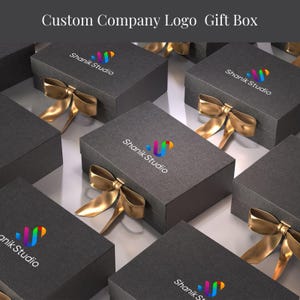 a collection of gray gift boxes with gold bows, each featuring the logo of Shank Studio.