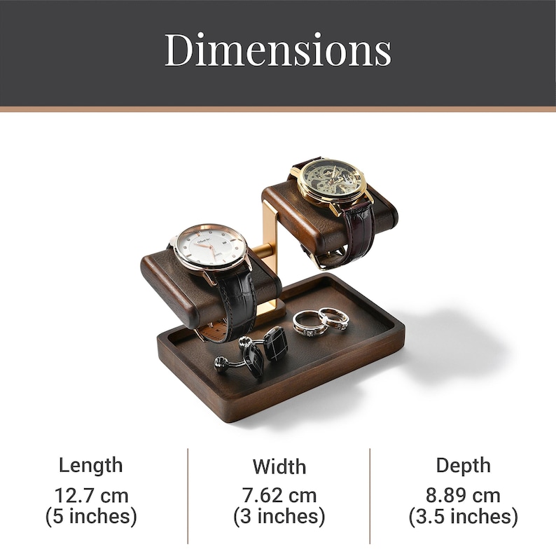 A wooden watch stand with two watches on it, along with some rings and a pen holder.