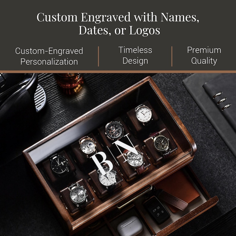 A wooden watch case with multiple watch faces visible inside, along with a black leather-bound notebook and a glass of wine.