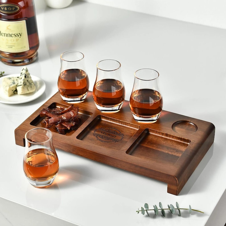 a selection of drinks and food items arranged on a wooden tray, accompanied by a bottle of Heineken wine.