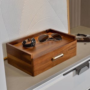 a pair of sunglasses sitting on top of a wooden box
