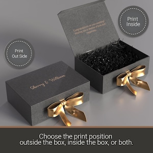 two gray gift boxes with gold bows, one open and one closed. The boxes are placed on a gray surface.