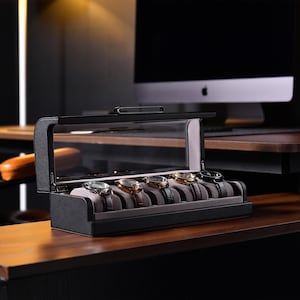 a wooden desk with a computer monitor and watch display