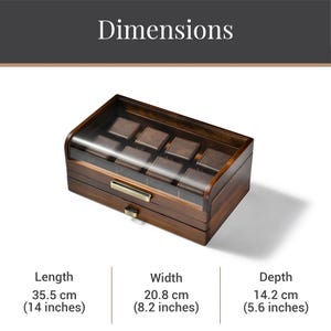 A wooden watch box with a clear glass front, displaying the dimensions of the watch box and the watch inside.