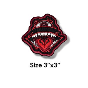 May include: Red and black embroidered patch with a large, open mouth with a red tongue and a single eye in the center. The patch is 3 inches by 3 inches.