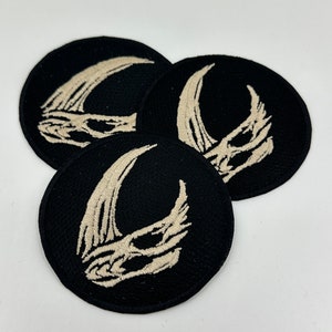 May include: Three black and white embroidered patches with a crescent moon design. The patches are circular and have a white crescent moon with a detailed design on a black background.