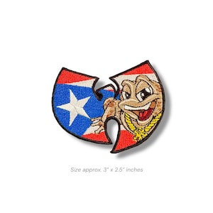 May include: Embroidered patch featuring a cartoon frog wearing a gold chain, set against a red, white, and blue background. The patch is approximately 3 inches by 2.5 inches. The design incorporates a star and flag elements.