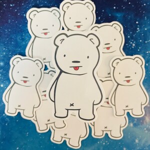 May include: A set of eight white polar bear stickers with black outlines and red tongues sticking out. The bears are all in the same pose, standing with their arms at their sides and their legs slightly apart. The stickers are arranged in a circle, with the largest bear in the center.