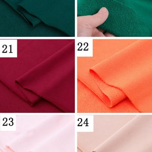 May include: Four different colors of fabric swatches. The swatches are arranged in a grid of four squares. The top left swatch is a dark green, the top right swatch is a bright green, the bottom left swatch is a dark red, and the bottom right swatch is a bright orange.