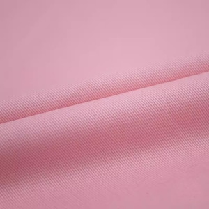 May include: A close-up of a soft, pink fabric with a subtle texture. The fabric is folded in half, creating a smooth curve.