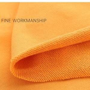 May include: Close-up of a bright orange fabric with a textured knit pattern. The fabric is folded over, showing the inside of the knit. The text "FINE WORKMANSHIP" is visible in the top left corner.