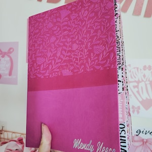 May include: A set of three ceramic mugs with a speckled, cream-colored glaze. Each mug features a different hand-painted floral design in shades of blue, green, and yellow. The mugs have a simple, rounded shape and a comfortable handle.