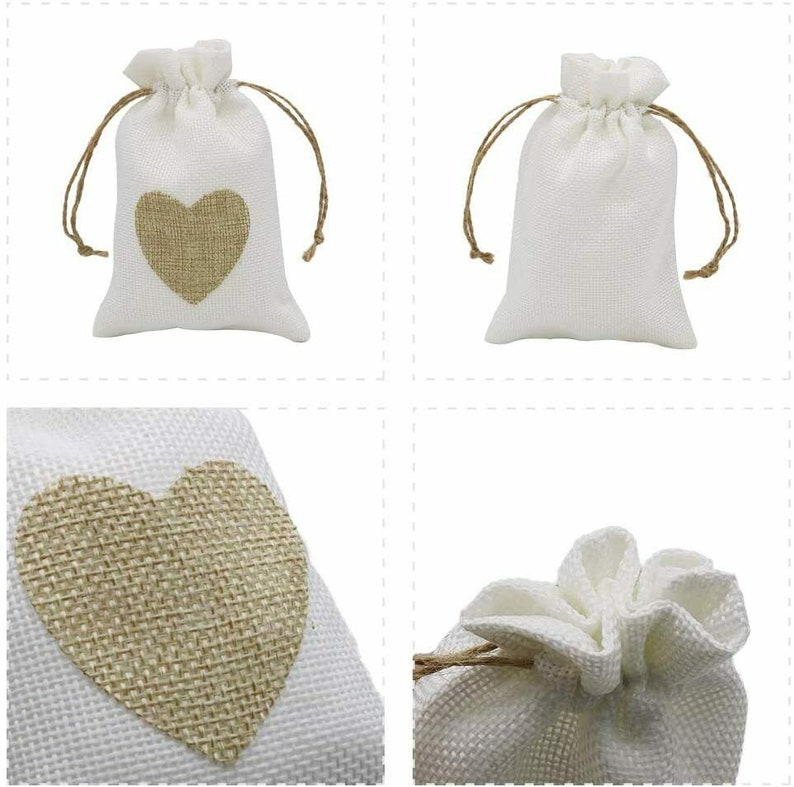 May include: Four white burlap drawstring bags with a brown burlap heart design. The bags are shown in different angles and positions.