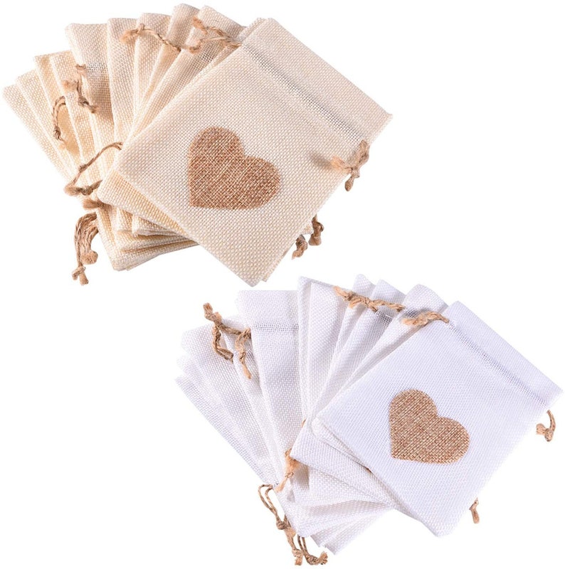 May include: Two sets of 10 small burlap drawstring bags with a heart-shaped design. One set is natural beige and the other is white. Each bag has a brown burlap heart sewn on the front.