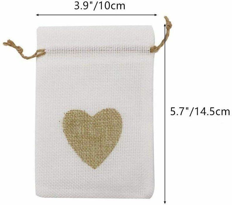 May include: A white burlap drawstring bag with a brown burlap heart in the center. The bag measures 5.7 inches tall and 3.9 inches wide.