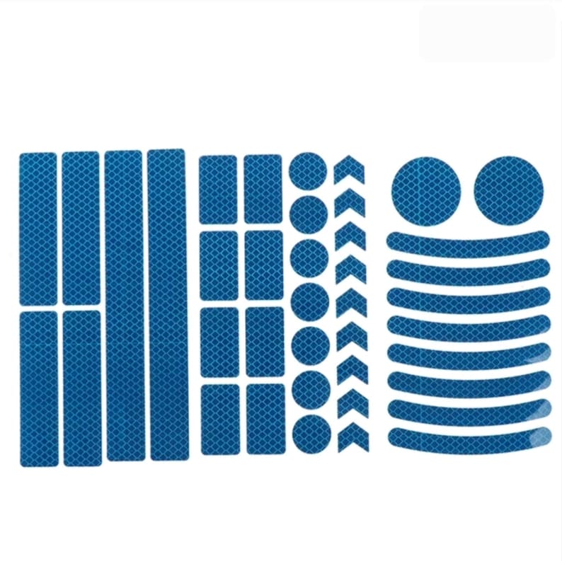 May include: A set of blue reflective stickers for bicycles. The set includes various shapes, including strips, rectangles, circles, and arrows. The stickers are designed to increase visibility and safety on the road.