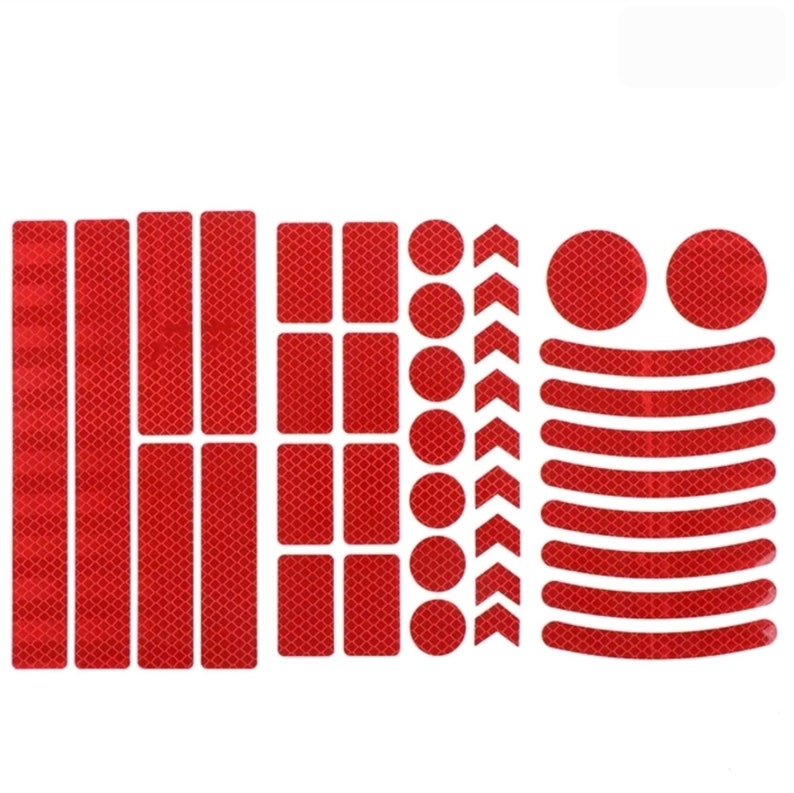 May include: A set of red reflective stickers for bicycles. The set includes various shapes, such as long strips, rectangles, circles, and arrows. The stickers are designed to increase visibility and safety on the road.