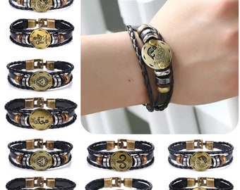 Può includere: Set di 12 braccialetti in pelle con segni zodiacali, perline metalliche e un ciondolo dorato con il simbolo zodiacale. Ogni braccialetto ha un cinturino in pelle nera con un accento in pelle marrone.