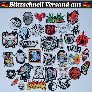 May include: A collection of colourful embroidered iron-on patches featuring various designs, including skulls, animals, motorcycles, and phrases like "Route 66", "No Club", "Lone Rider", "Game Over", and "Love".