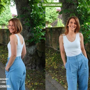 May include: A woman wearing a white tank top and high-waisted, light blue pants. The pants have a pleated front. The image is taken outdoors with trees and a stone wall in the background. Text on the image reads "V-NECK / V-AUSSCHNITT LENGTH 1 / L&Auml;NGE 1 #SEWINGMACHINATILL".