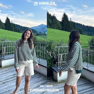 May include: A woman wearing a green and white striped sweater and white shorts stands on a wooden deck with a mountain view in the background. The text "#SEWINGMACHINAANTON" is visible on the deck.
