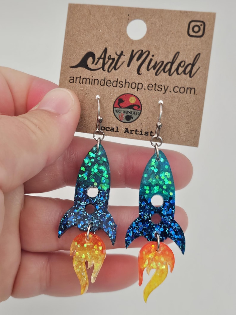 May include: A set of three ceramic mugs with a speckled, matte finish. The mugs are in shades of cream, light gray, and dark gray. Each mug has a simple, minimalist design, perfect for coffee or tea.