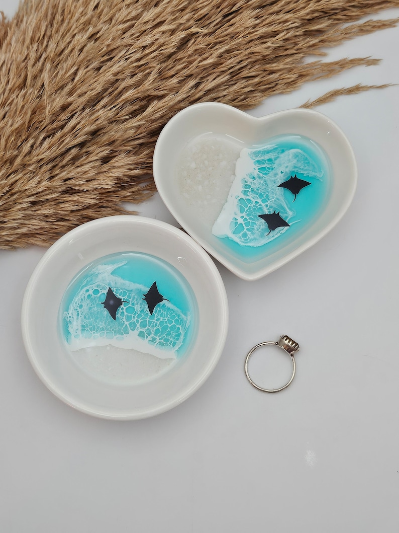 May include: A set of three ceramic mugs with a speckled, matte finish. The mugs are in shades of cream, light gray, and dark gray. Each mug has a simple, minimalist design, perfect for coffee or tea.