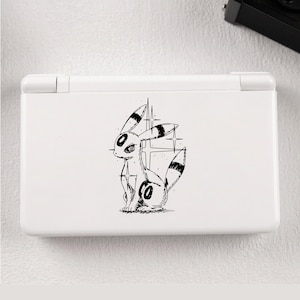 May include: A white handheld gaming console featuring a black and white line art illustration of a seated creature with long ears, a bushy tail, and circular markings on its forehead and hip, accented by four-pointed star shapes in the background.