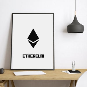 May include: A rectangular framed wall art piece featuring a white background with a centred black Ethereum logo and the word ETHEREUM printed in a bold, black, sans-serif font below the icon. The frame is thin and black, enclosing the print.