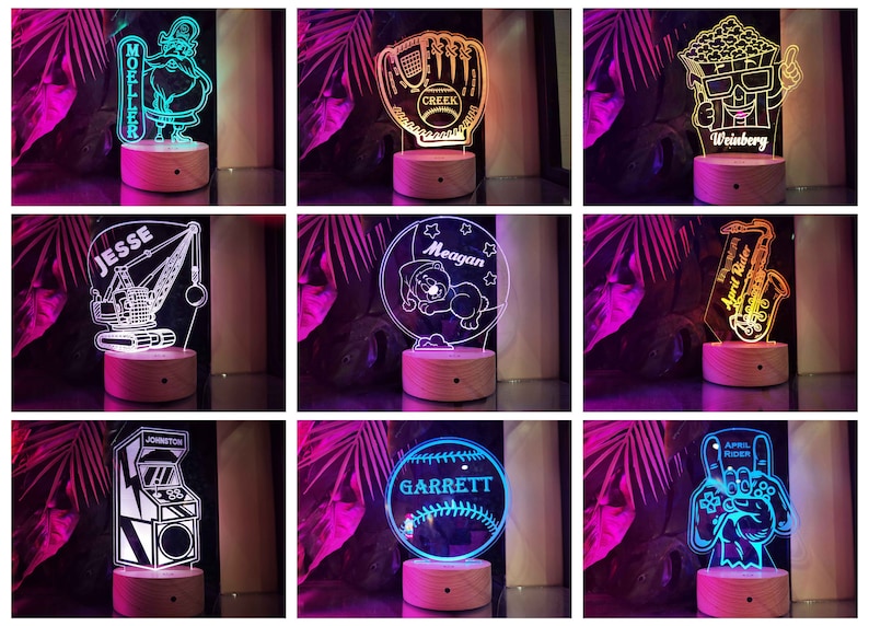 May include: Nine different personalized night lights with various designs, including a baseball glove, a sleeping bear, a construction crane, a video game, a popcorn bucket, a saxophone, and a Santa Claus. Each light has a wooden base and a clear acrylic panel with a white design.