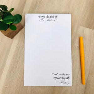 May include: White notepad with the text "From the desk of: Ms. Anderson" at the top and "Don't make me repeat myself. - History" at the bottom.