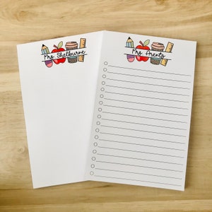 May include: Two white notepads with lined pages and a checklist. The top of each notepad has a colorful illustration of a red apple, a coffee cup, a pencil, and a ruler. The text "Mrs. Shelbourne" is on the left notepad and "Mrs. Arents" is on the right notepad.