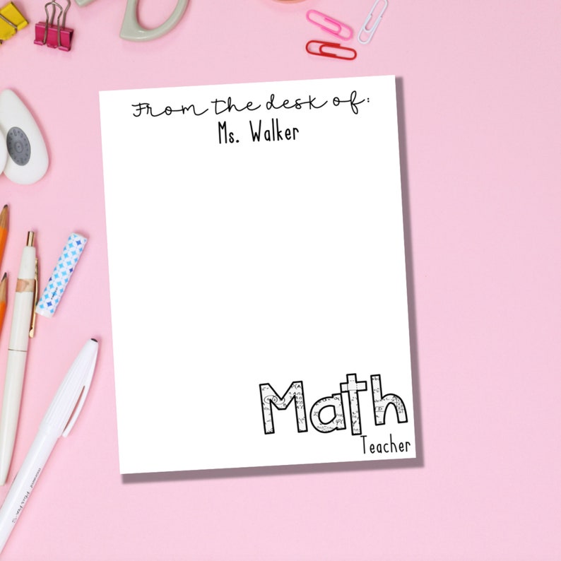 May include: White notepad with black text that says "From the desk of: Ms. Walker" at the top and "Math Teacher" at the bottom.