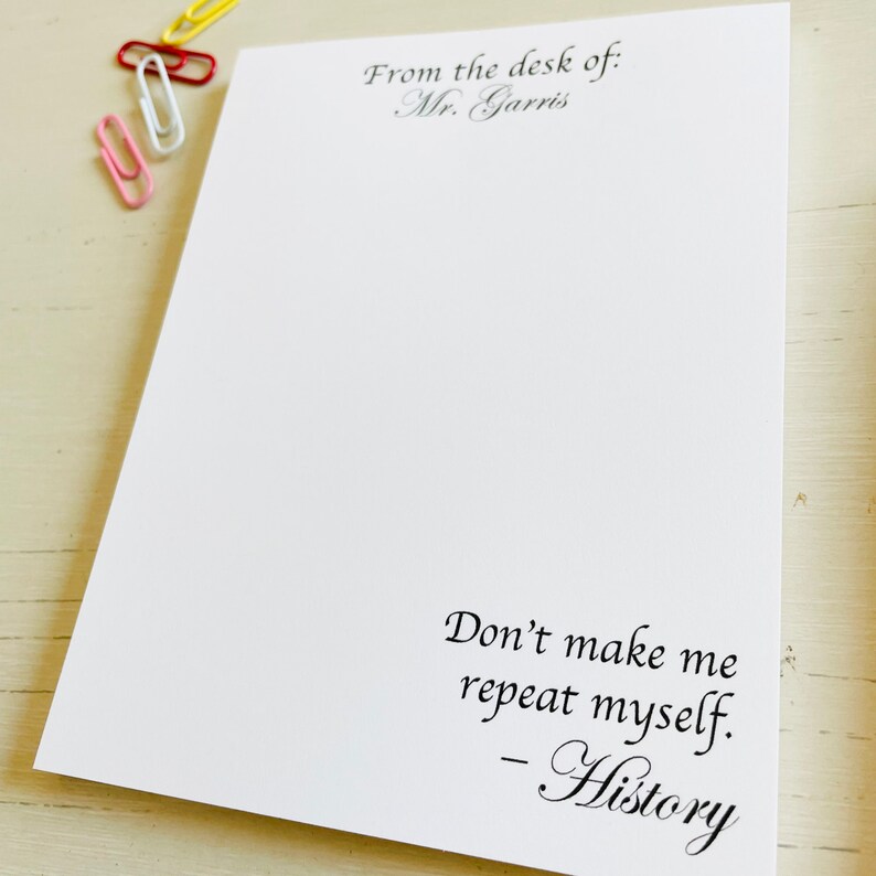 May include: White notepad with the text "From the desk of: Mr. Garris" at the top and the text "Don't make me repeat myself. -History" at the bottom.
