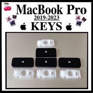 May include: Black and white MacBook Pro keys, with the text "MacBook Pro 2019-2023 KEYS". The image shows several black keys with white arrow symbols and white key stabilizers.