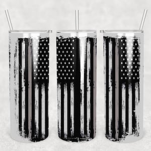 May include: Three stainless steel tumblers with a distressed American flag design and a thin gray stripe down the center. The tumblers are all the same size and have a silver finish.