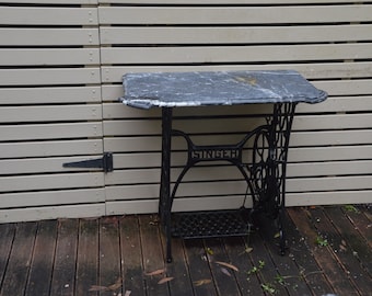 A Cast Iron Singer Machine Base and Marble Topped Table