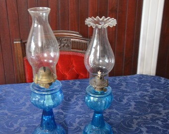 A Graduated Pair of Blue Glass Turkey Foot Oil Lamps