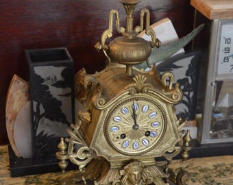An Antique French Brass Clock Featuring Griffins