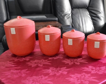 A Set of 4 Mottled Red and Cream Bakelite Canisters
