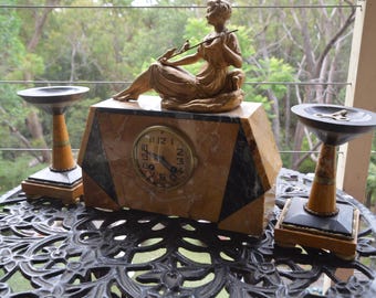 A Marble Cased Antique French Clock featuring a Seated Lady and Birds and Garnitures