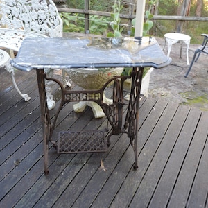 A Singer Sewing Based Marble Top Patio Table