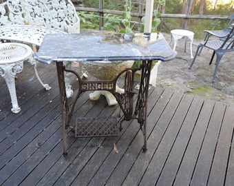 A Singer Sewing Based Marble Top Patio Table