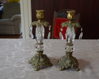 A Pair of Art Nouveau Brass and Glass Candle Stands