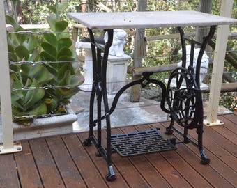 A Cast Iron Based Sewing Machine Marble Topped Table
