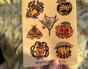 May include: A sheet of Halloween-themed planner stickers. The stickers feature illustrations of a jack-o'-lantern, a spider web, a moth, an acorn, and a cat wearing a witch hat. The text "Everyday is Halloween!" is printed at the top.
