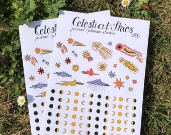May include: Two sheets of stickers featuring celestial themed illustrations. The stickers are white with black, yellow, and orange illustrations of stars, moons, clouds, and shooting stars. The text "Celestial Skies" and "journal/planner stickers" is printed on the top sheet. The text "@maya.c.illustration. TulipsandHeatherShop" and "@maya.x." is printed on the bottom sheet.